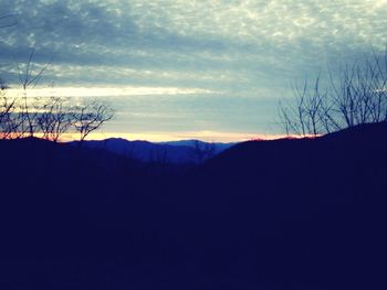 Scenic view of mountains against cloudy sky