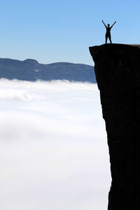 Silhouette man standing on mountain