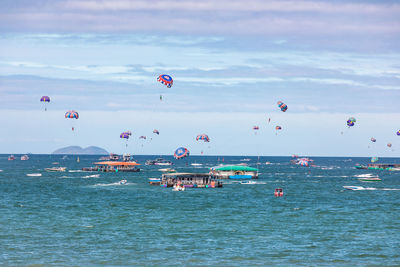 People parasailing at pattaya beach thailand