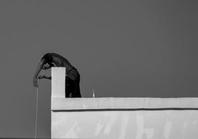 Low angle view of man standing against sky
