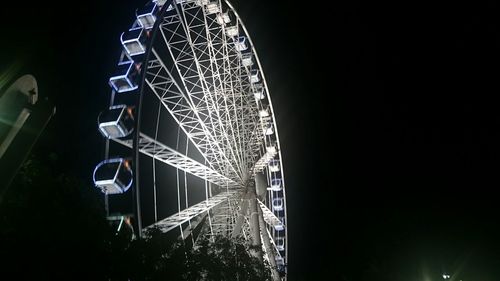 Low angle view of illuminated ferris wheel