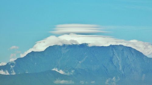 Scenic view of mountains against blue sky