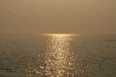 Scenic view of sea against sky at sunset