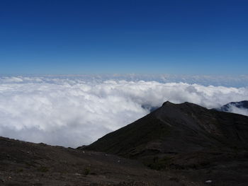 Scenic view of mountains against blue sky