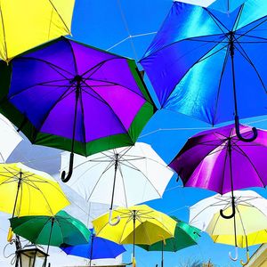 Low angle view of multi colored umbrella against sky