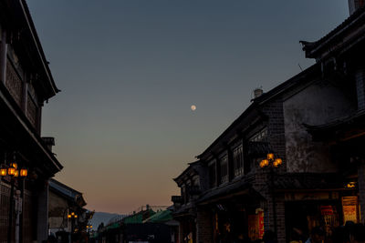 Low angle view of illuminated buildings against sky at night