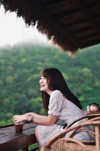 Young woman sitting outdoors