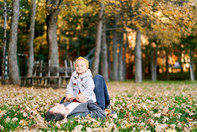 Portrait of young man using digital tablet while sitting in park