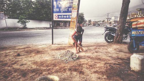 Woman walking on road in city