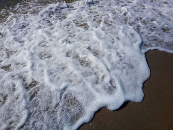 High angle view of surf on beach
