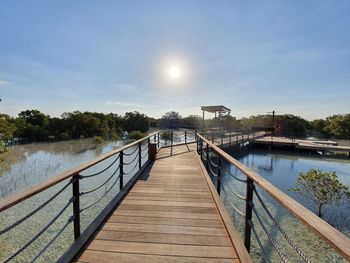 Pier over river against sky