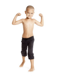 Portrait of happy boy standing against white background