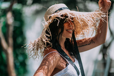 Portrait of young woman wearing hat outdoors