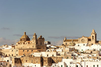 Buildings in city against sky