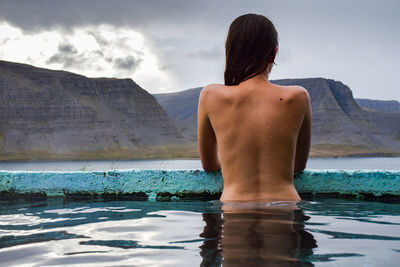 Rear view of topless woman in vacations