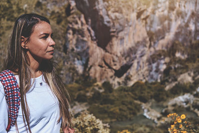 Young tourist walks on a path to the mountain. adventure travel, hiking concept.