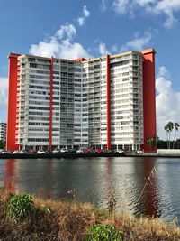 Building by river against sky