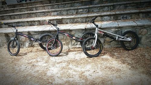 Bicycles on bicycle parked against wall