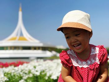 Smiling girl against building in city