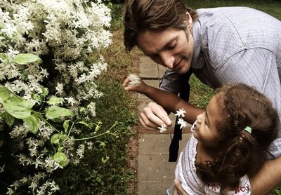 Father and daughter while standing by plants