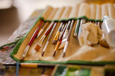 Close-up of paint brushes on table