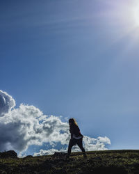 Full length of woman standing against sky