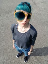 High angle view of boy wearing sunglasses standing outdoors