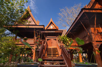 Low angle view of building and trees against sky