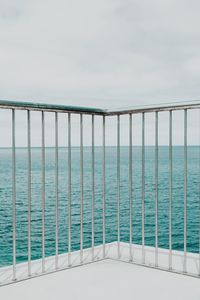 Swimming pool by sea against sky