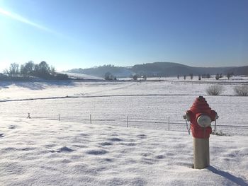 Fire hydrant on snowcapped field during winter