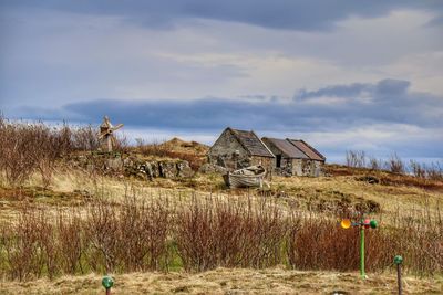 Houses on landscape against sky