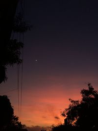 Low angle view of silhouette trees against sky at sunset