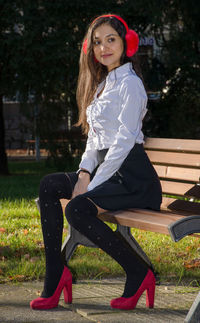 Portrait of young woman sitting outdoors
