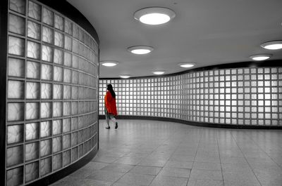 Man walking in illuminated corridor