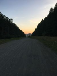 Road amidst trees against sky