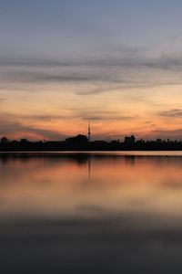 Scenic view of lake against sky during sunset