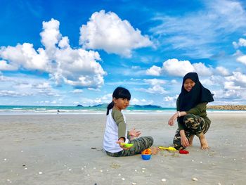 Portrait of siblings playing at beach