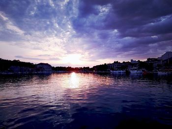Scenic view of lake against sky at sunset