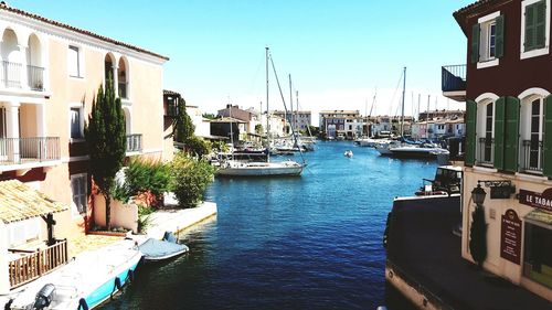 View of boats in canal along buildings