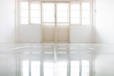 White room area, wrought iron door pattern in the middle of the room