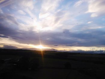 Scenic view of landscape against cloudy sky