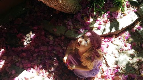 Portrait of beautiful woman with pink flower on tree