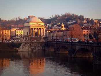 Bridge over river with city in background