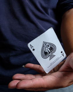 Midsection of man playing poker