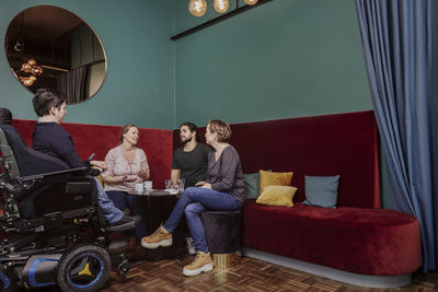 People sitting on sofa at home