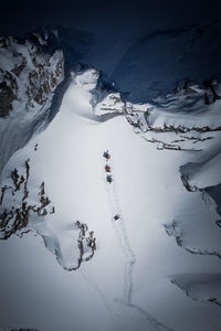 People skiing on snowcapped mountain