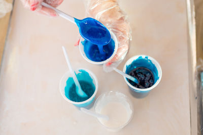 High angle view of blue drinking glass on table