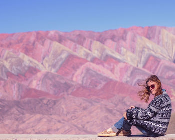 Woman sitting on mountain