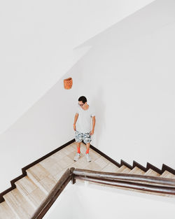 High angle view of man standing on staircase