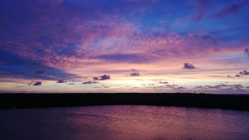 Scenic view of lake against romantic sky at sunset